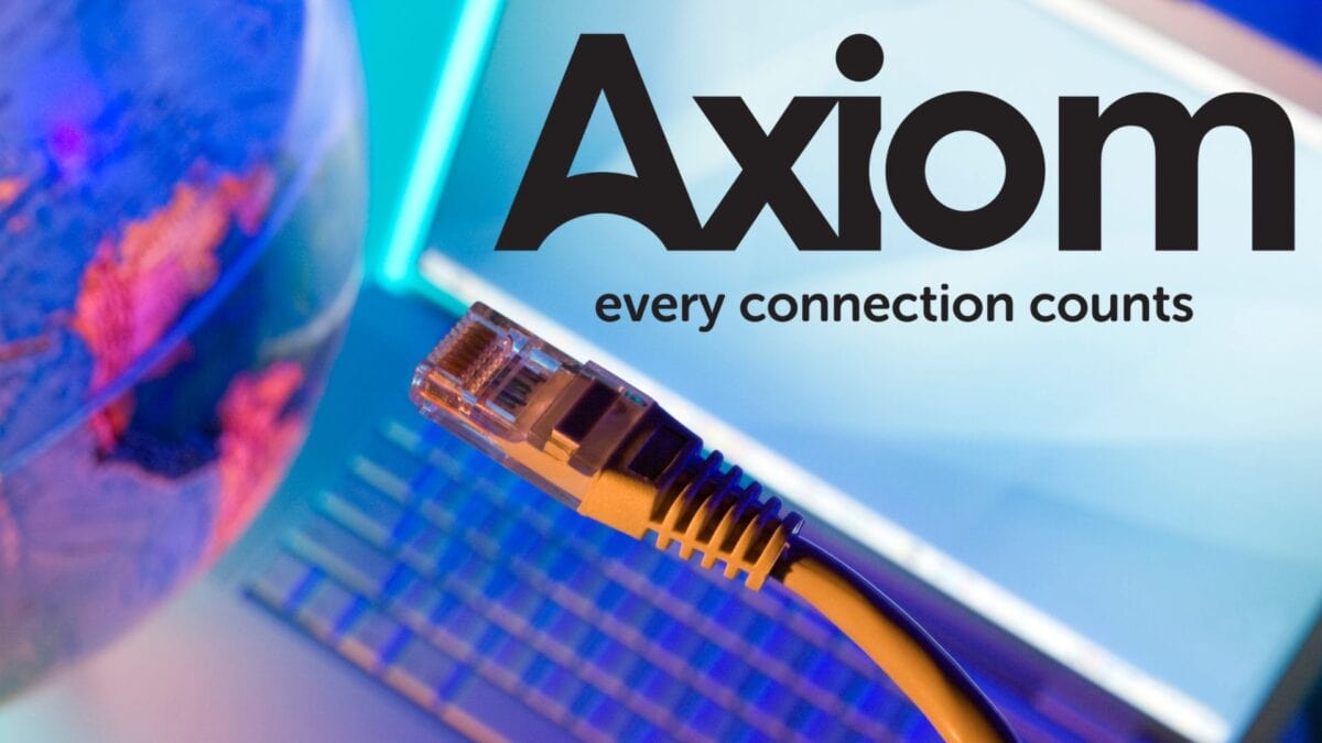 a close up of a network cable in front of a laptop keyboard, with the text axiom every connection counts displayed prominently in bold black letters.