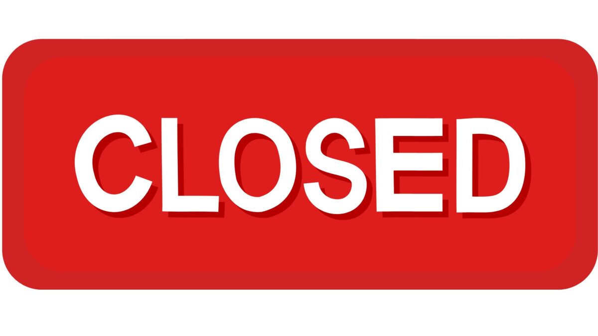 a red rectangular sign with the word closed in bold, white, capital letters centered.
